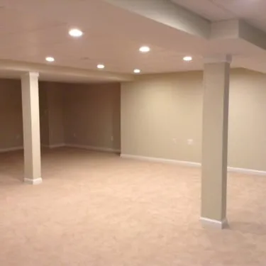 Finished basement room with cream walls, carpet, and recessed lighting